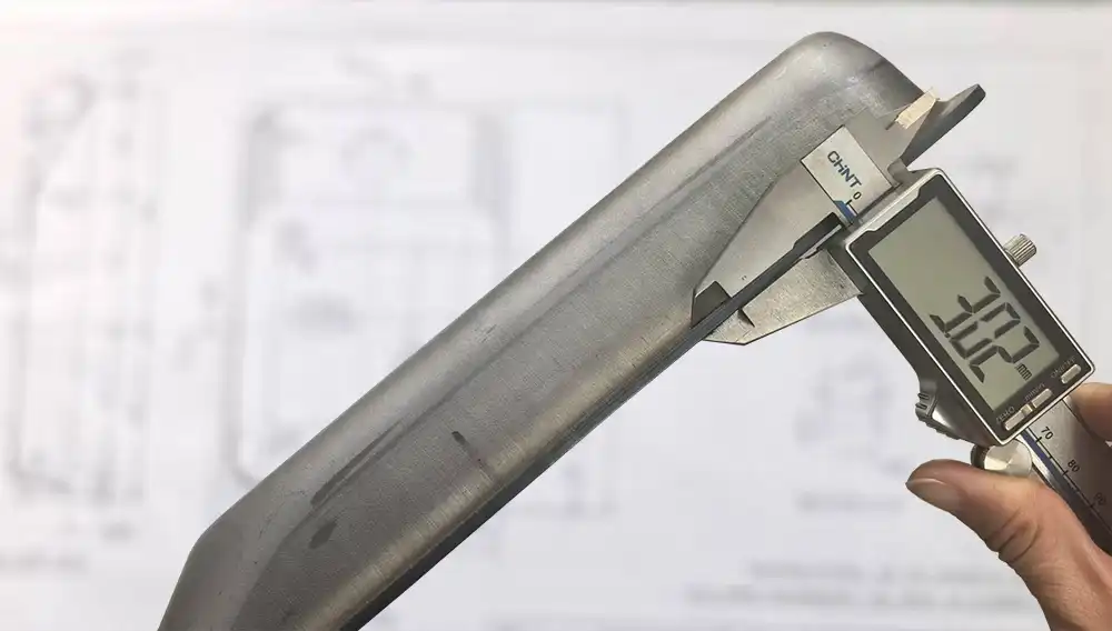 caliper measuring metal part tolerance