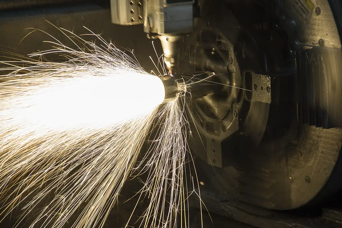 Close-up of laser tube cutting machine with bright sparks during precision stainless steel tube processing at Conwhole factory
