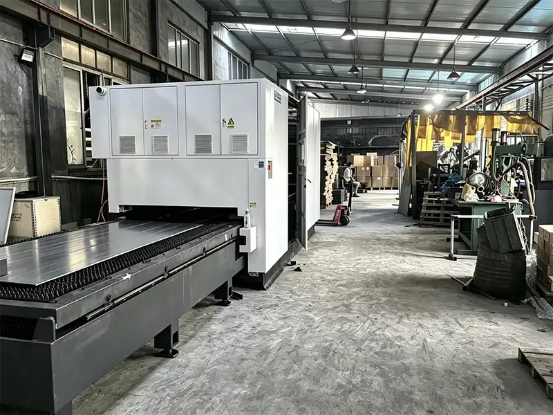 Modern metal fabrication factory floor showing laser cutting, CNC machining, robotic welding, and stamping stations in one facility