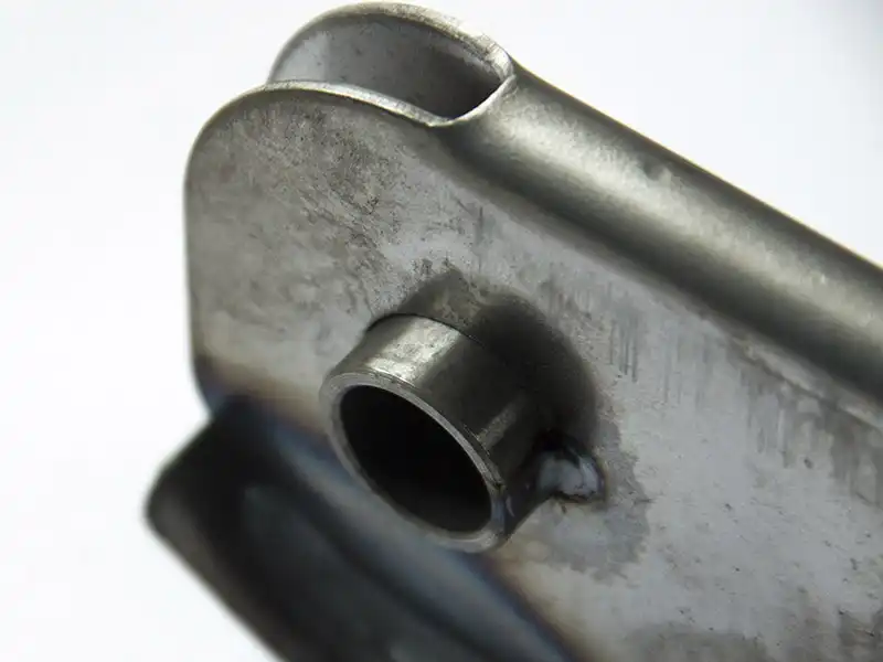 Tractor brake handle bushing welding detail