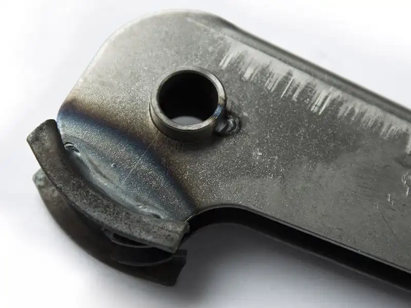 Tractor brake handle welded bushing detail